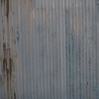 塗装が劣化してボロボロになった波板のテクスチャの写真