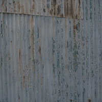 塗装が剥げた古い波板のテクスチャの写真