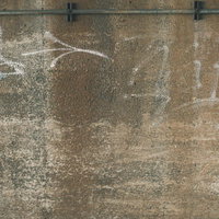 コンクリート擁壁に描かれた白いスプレー落書きの写真