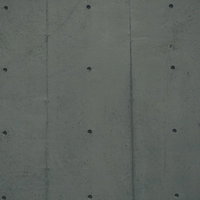 規則正しく整列したPコン穴のコンクリート壁テクスチャの写真
