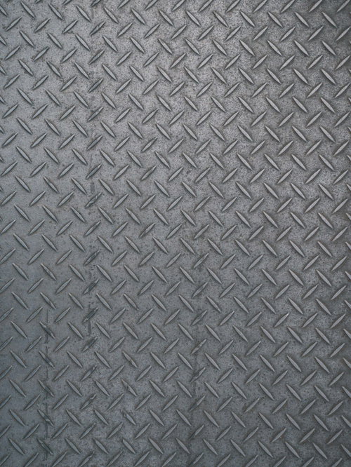 グレーの鋼板に施された滑り止め加工のテクスチャ