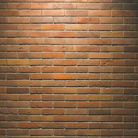 照明で陰影が生まれるレンガ壁のテクスチャーの写真