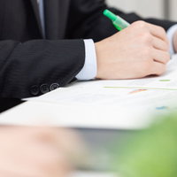 資料に訂正をいれるビジネスマンのポートレートの写真