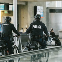 空港ターミナル内を自転車で巡回中のポリスメンの写真
