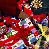 赤と金のリボンが付いたクリスマスプレゼントの山の写真