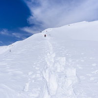 新雪の中を歩く登山者たち、谷川岳の冬景色の写真