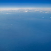 飛行機から見た海と空の水平線の写真