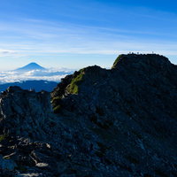 日本最高峰の富士山と二位の北岳がシルエットで並ぶ夕暮れの山岳景観の写真