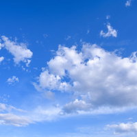 梅雨時期の青空に浮かぶ白い雲と積雲の風景の写真