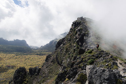 雲が押し寄せる浅間山の外輪山火口縁の岩峰