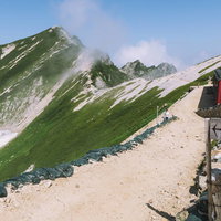 五竜岳から唐松岳へ続く稜線の山小屋と指導標の写真