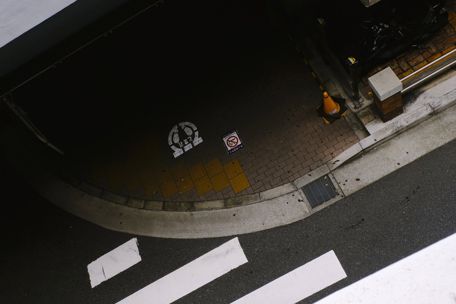 夜の暗い道路に引かれた白い横断歩道と止まれの標識
