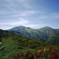 古寺山から見る大朝日岳の稜線と青空の山々の写真