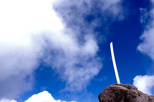 男体山山頂の岩に突き刺さる刀の刃と青空の景色