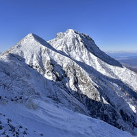冬の文三郎尾根中腹から見る雪化粧した阿弥陀岳の写真