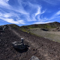 岩手山山頂へと続く登山道、荒地を貫く一本の道の写真