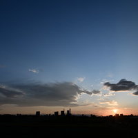 夕焼けに染まる地方都市の空と建物のシルエットの写真