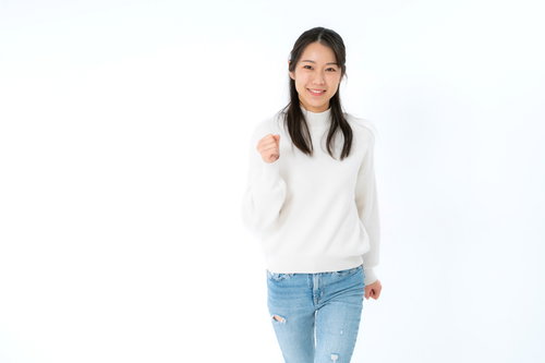 白いスウェットでウォーキングする笑顔の女性