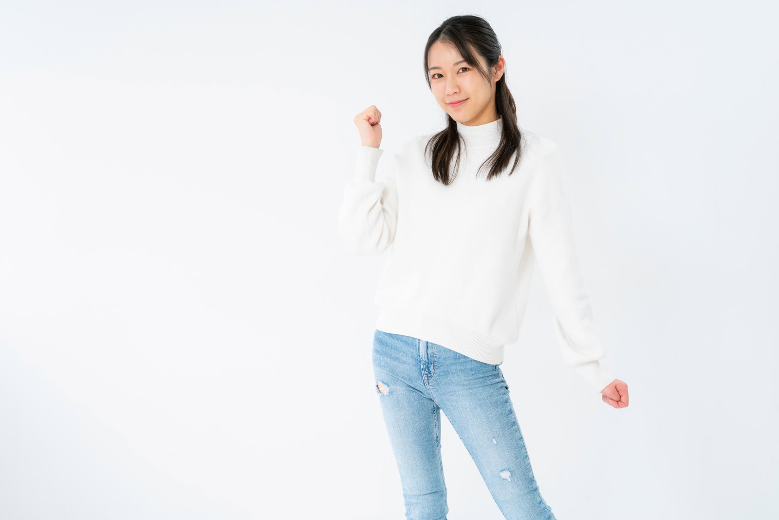 Young woman smiling with a fist pump pose