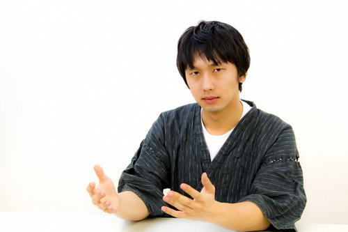 白いテーブルでドヤ顔のろくろ回しジェスチャーの男性