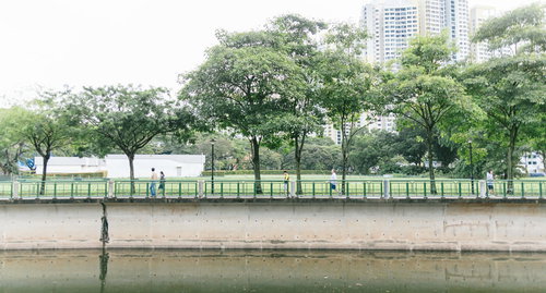 シンガポール川沿いを散歩する人たちと都市景観