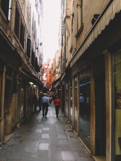 ヴェネツィアの路地裏を行き交う観光客と歴史的な街並み（イタリア）