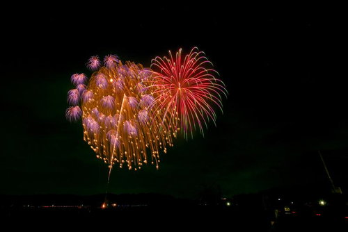 浅川の花火大会で夜空に咲く打ち上げ花火の閃光