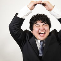 ビジネスマンがスーツ姿で決めるガッツポーズの成功の写真