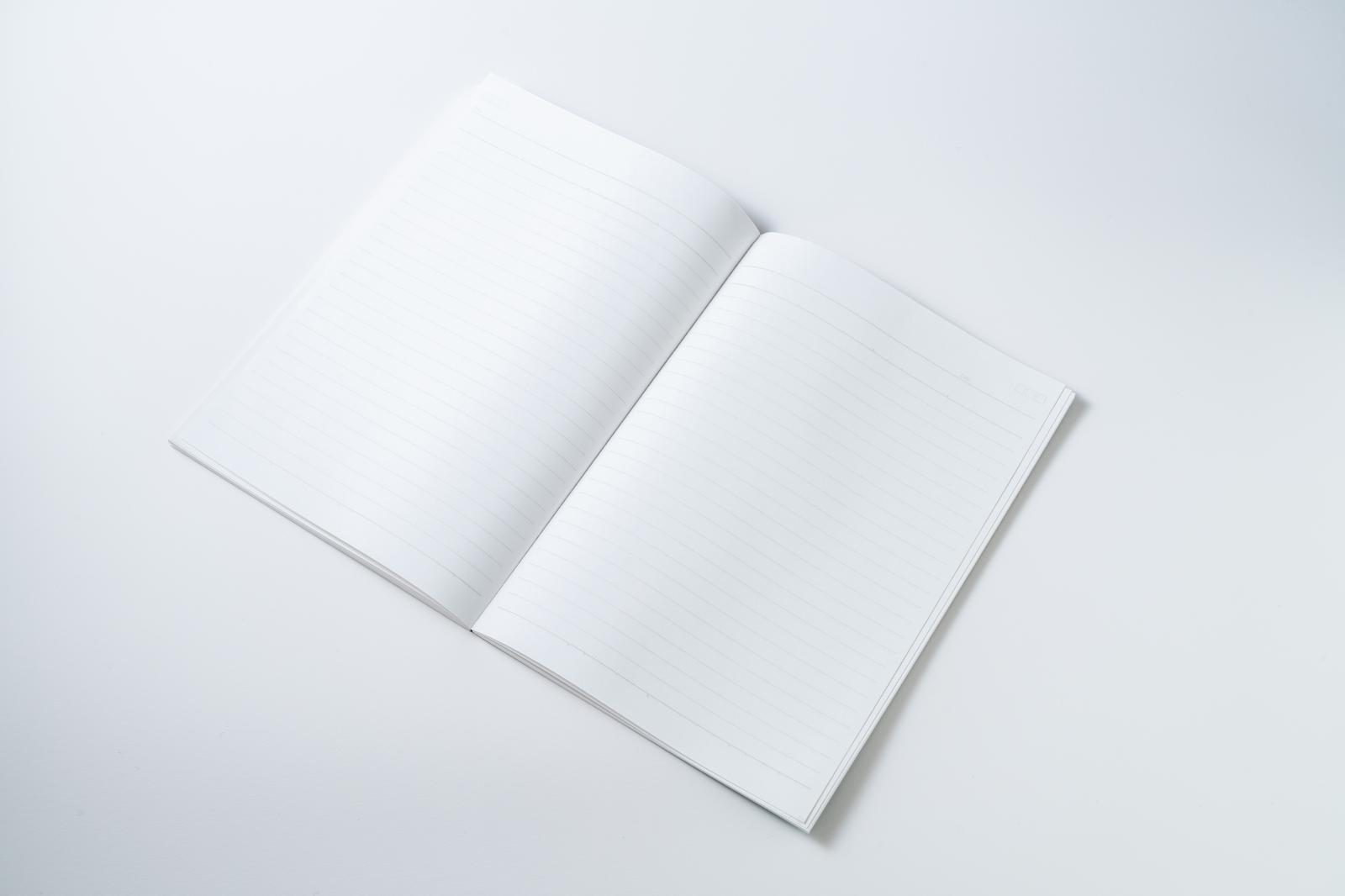 Open notebook with blank white pages and horizontal lines on a white background