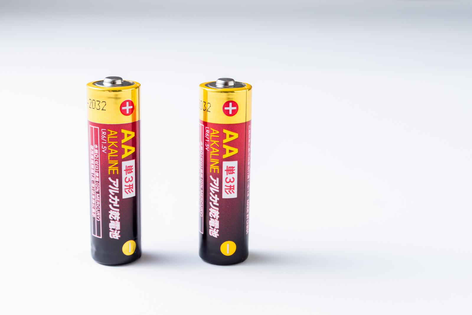 Two AA alkaline batteries arranged on a white background