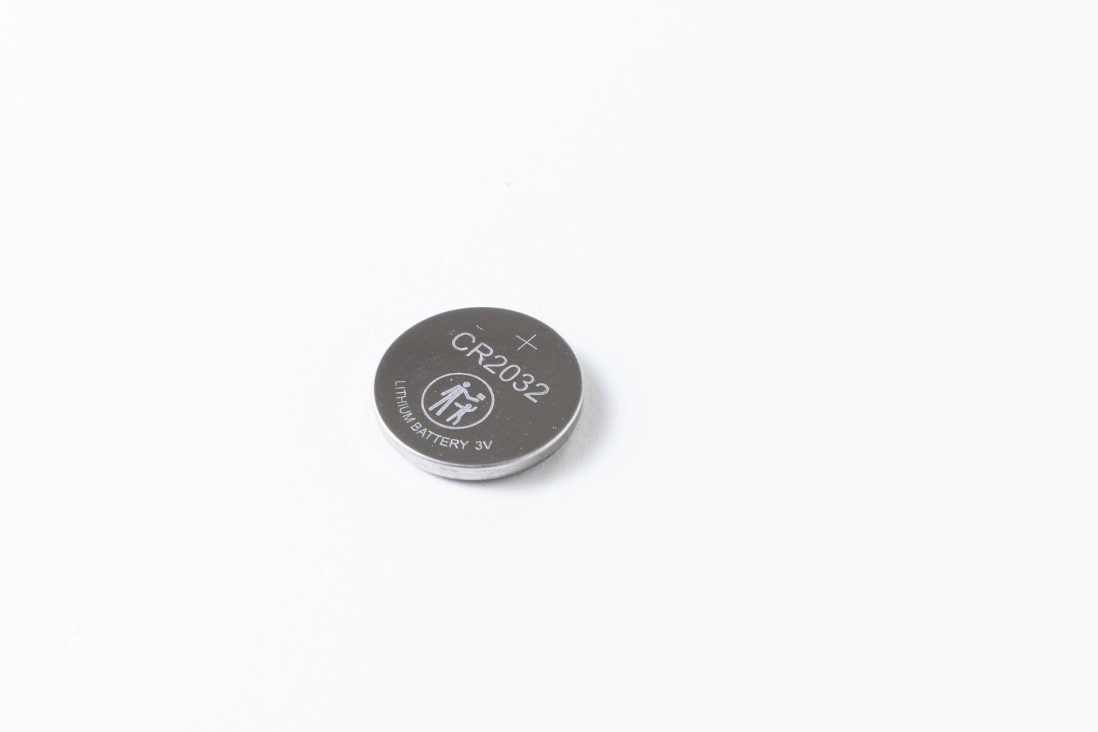 Silver coin battery with 'CR2032' marking on white background