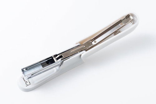 開いた白いホチキスの内部メカニズムと金属部品構造