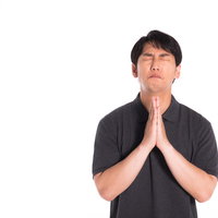 全力で手を合わせてお願い事をする男性の祈りのポーズの写真
