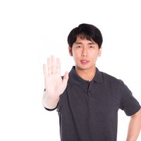 手を上げて抵抗する男性の制止ポーズ、ストップジェスチャーの写真