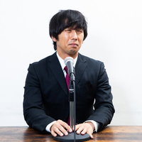 苦渋の表情で記者会見に臨む不祥事の男性による謝罪会見の写真