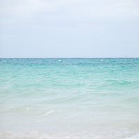 宮古島の青緑の海に打ち寄せる波の写真