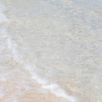 宮古島の透き通る海と波打ち際の白い泡立つ波の写真