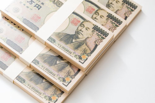 白い背景に積み重ねた偽札の札束