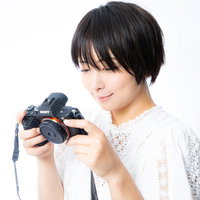 満足気な写真が撮れて笑みが溢れるカメラ女子のポートレートの写真