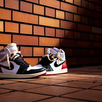 レンガの壁の前に置かれたNIKEのスニーカーの写真