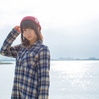 海面に反射したキラキラと女性の待ち合わせの写真