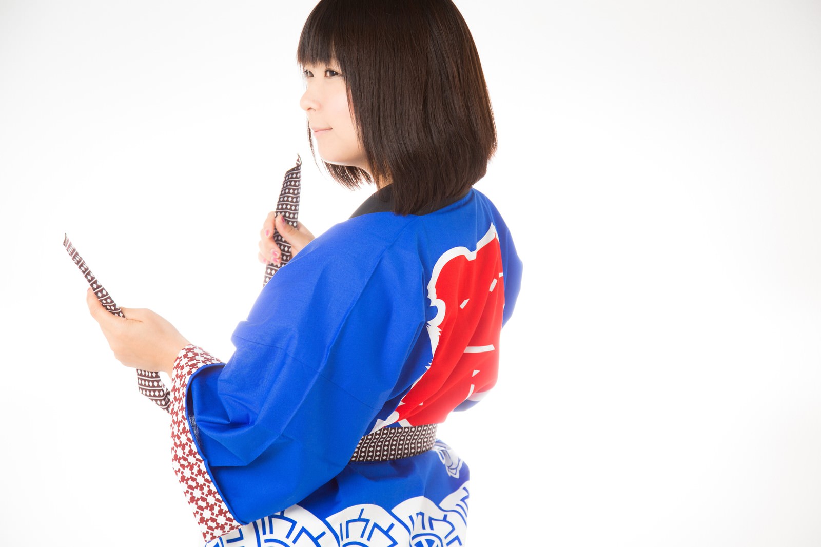 紅白の半被を着て肩越しに振り返る女性［モデル：にゃるる］