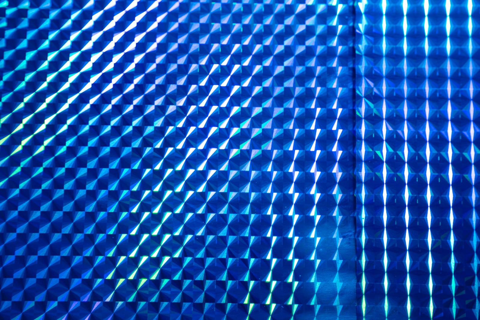 Glowing blue hologram-like prism pattern background