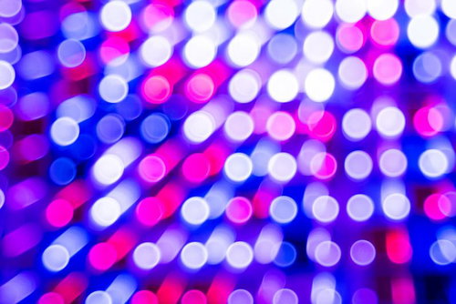 ホロカード風のキラキラした光の玉が並ぶグラデーション背景