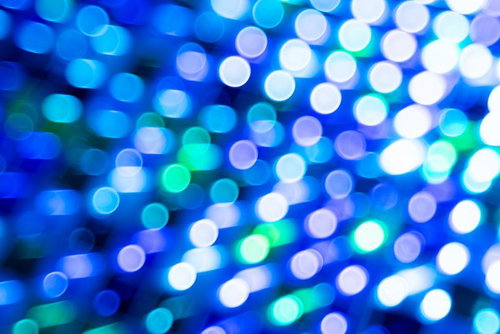 光る円形ボケが輝くホロカード風デジタル背景