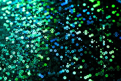 青緑グラデーションの円形光粒子パターン