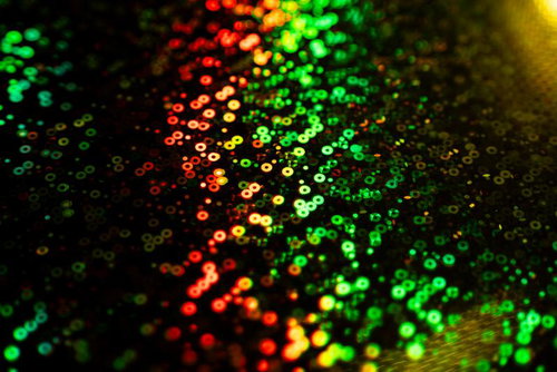 赤から緑へグラデーションする無数のキラキラした円形ボケの光