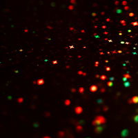 パーティーシーンで使える赤緑のキラキラ光背景の写真