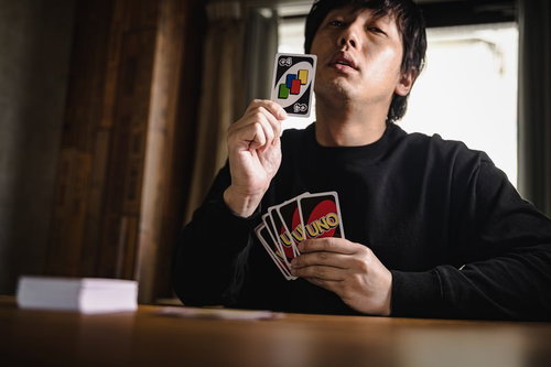 最強のカード、ドロー4を出すプレイヤーの得意げな表情