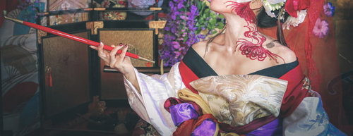 キセルの煙を優雅に吹きかける花魁の着物姿